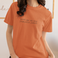 Person wearing an orange t-shirt with 'meet me at the pumpkin patch' text.