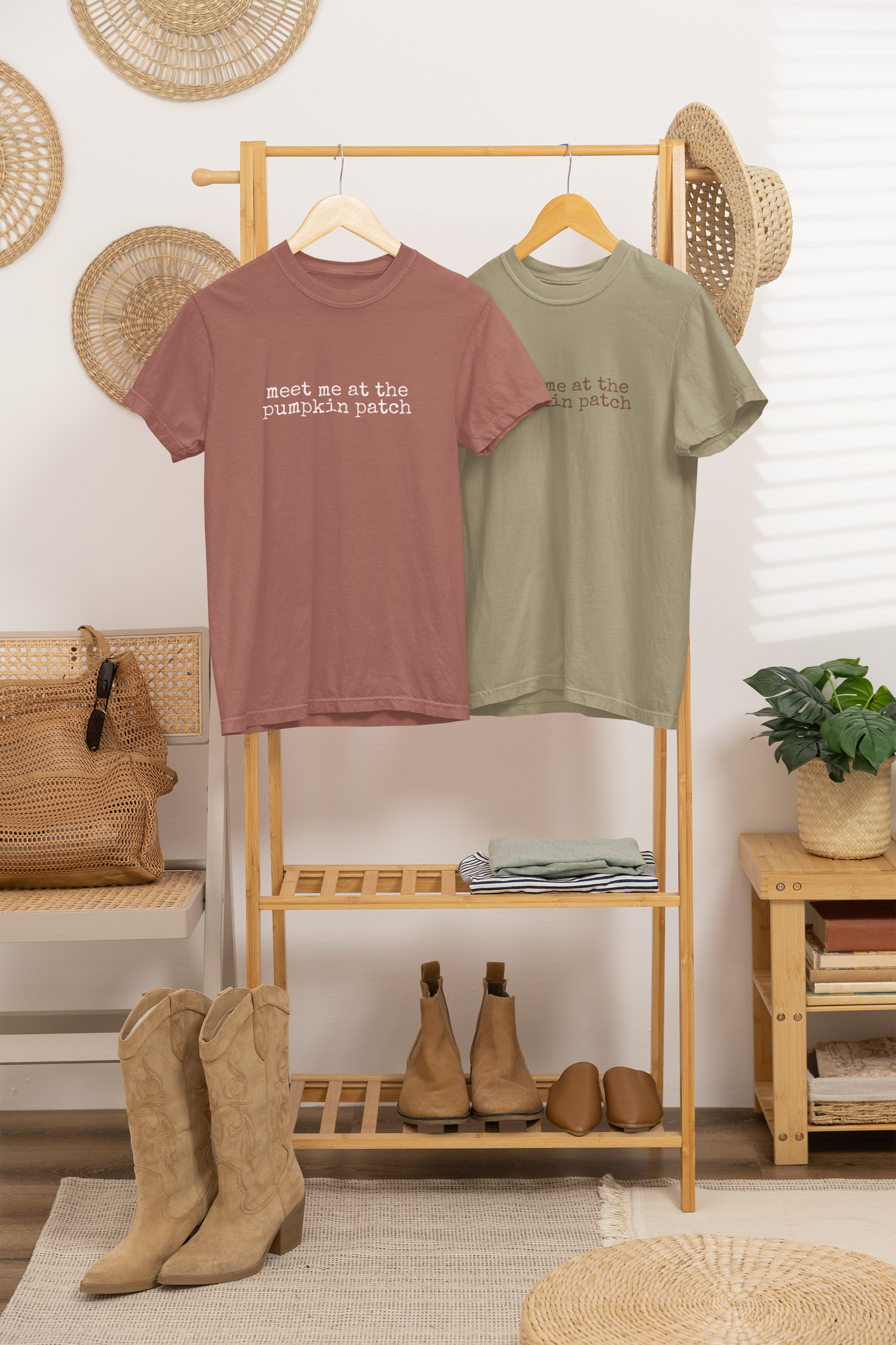 Two t-shirts on a rack with boots and decor items in a room.