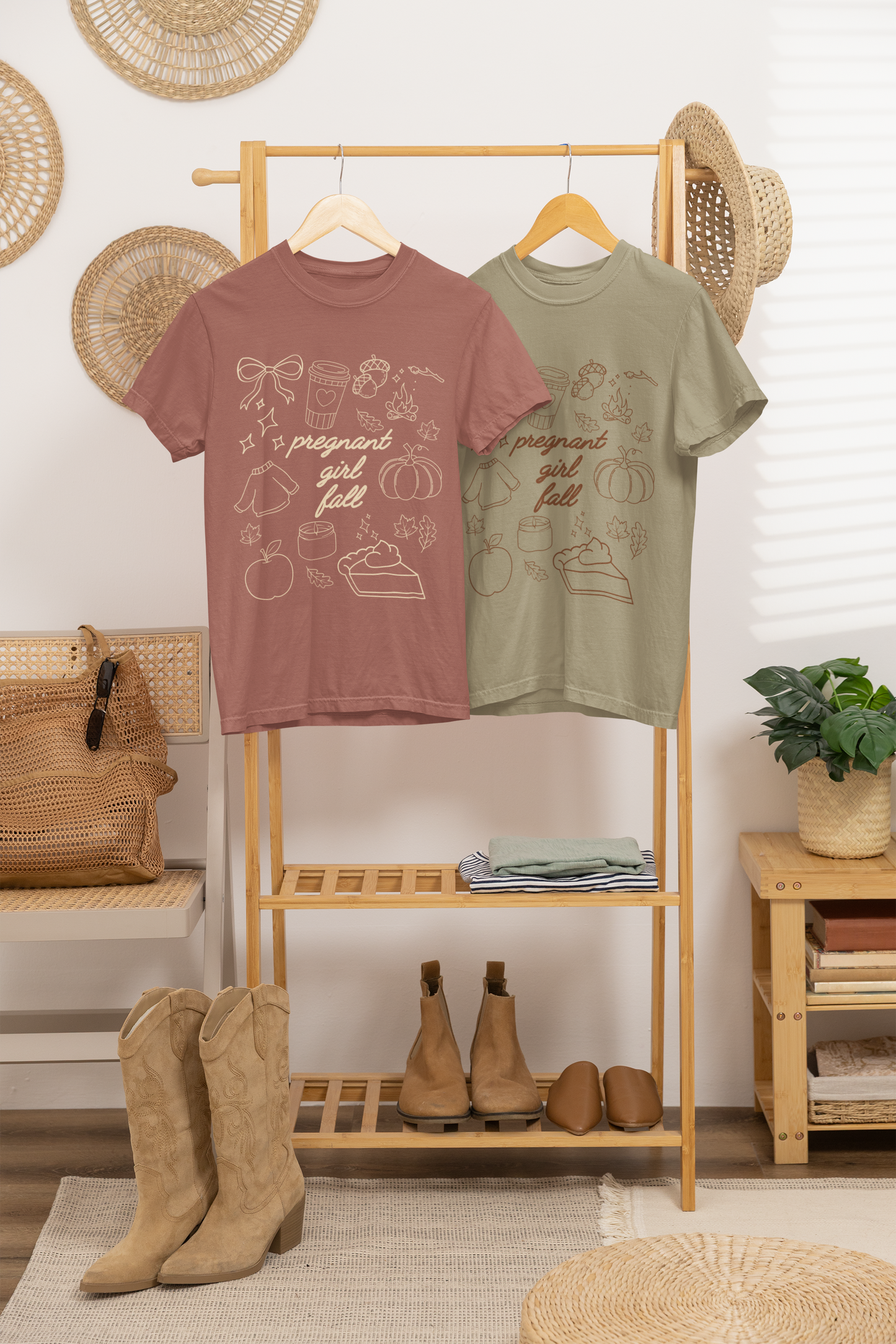 Two t-shirts on a rack with boots and a plant in the background